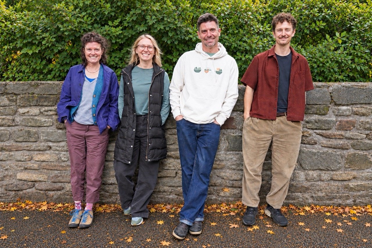 Greenheart Design Team Kate, Sonia, Henry and George standing by stone wall outside